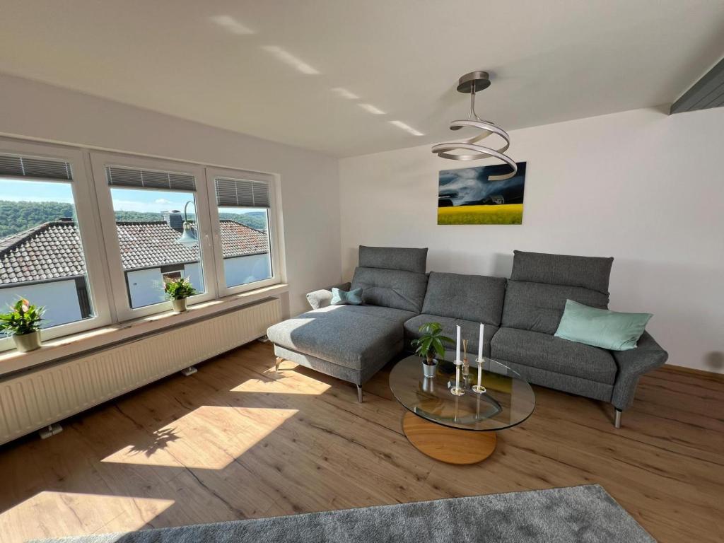 a living room with a couch and a table at Villa Basilika - Ferienwohnung Prüm in Prüm