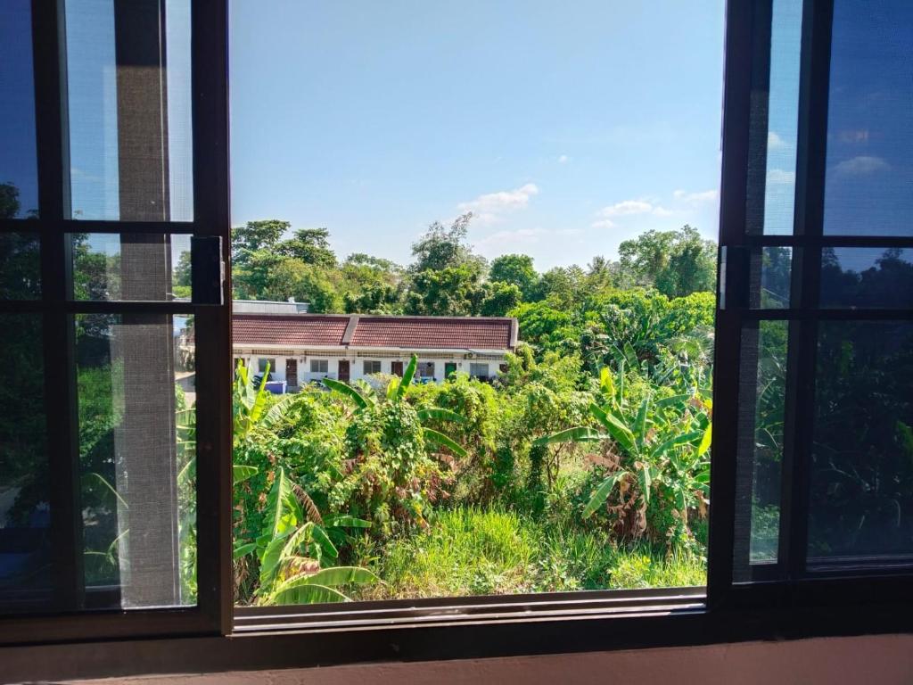 an open window with a view of a building at Krabi Hotel Agency in Krabi
