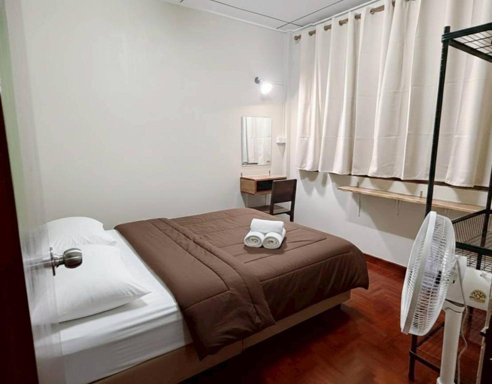 a bedroom with a bed with two white towels on it at MANITA Banyainim in Krabi