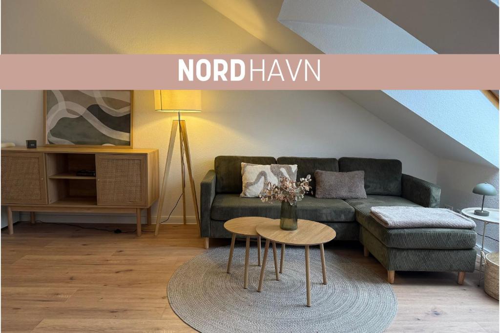 a living room with a couch and a table at Nordhavn in Harrislee