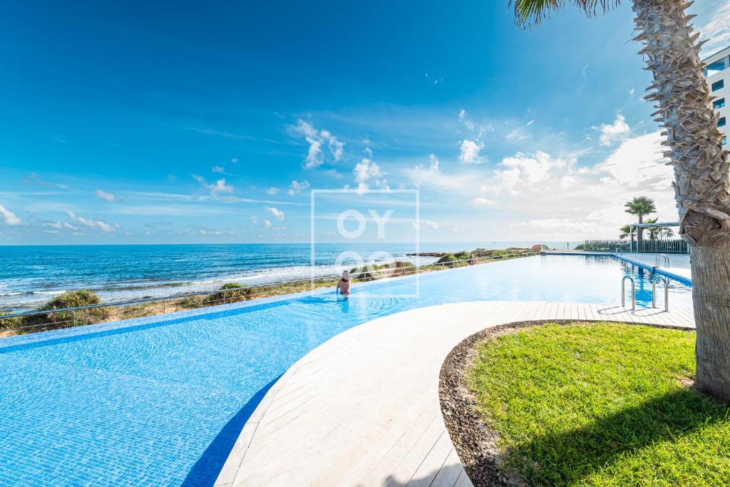 Beachfront Bliss apt, with heated pool, by OYOOSTAYS