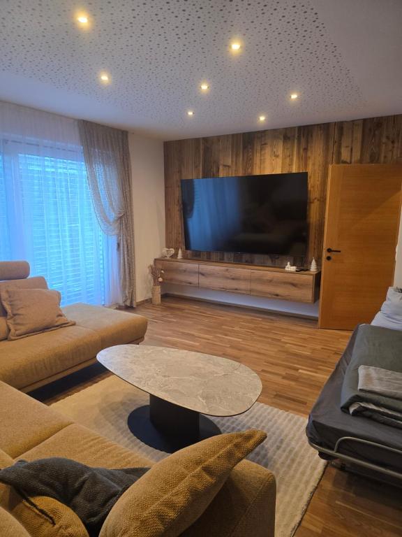 a living room with a large flat screen tv at Haus Levi in Imst