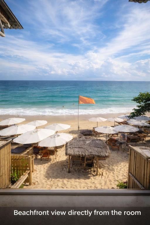a view of a beach with umbrellas and the ocean at Noahs Ark Beachfront in Lamai
