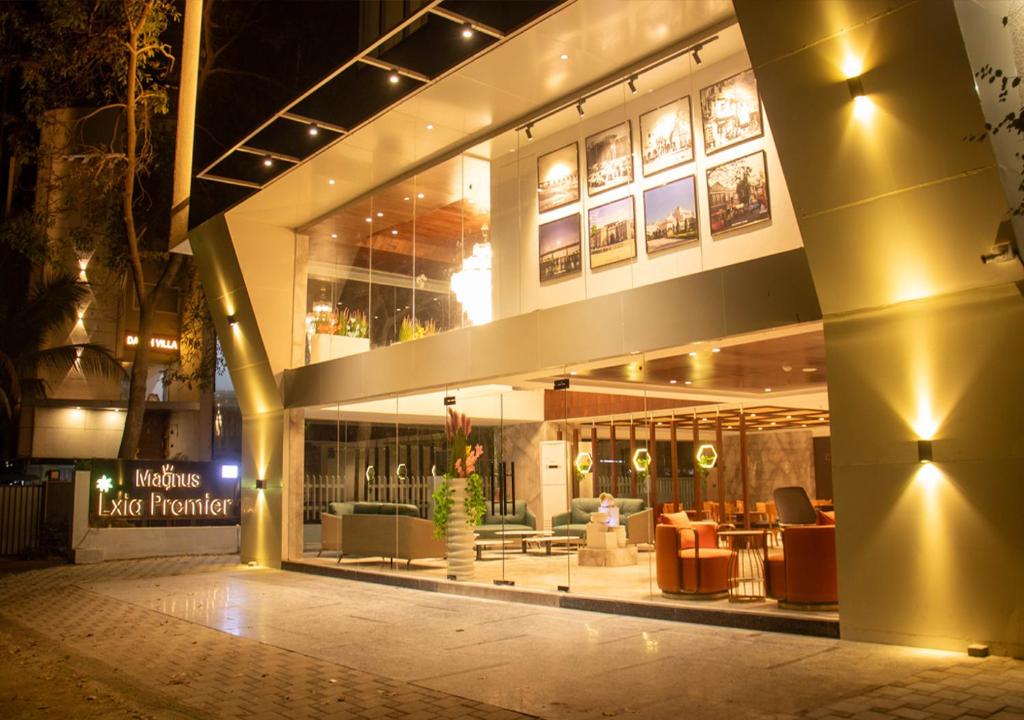 a lobby of a building with a restaurant at night at Magnus Lxia Premier, Kalyani Nagar Pune in Pune