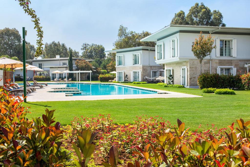a house with a swimming pool in a yard at Azure Villas By Cornelia in Belek