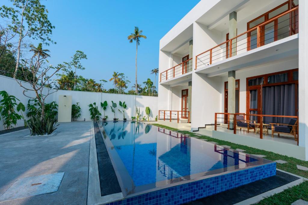 an exterior view of a house with a swimming pool at KIRI's HEAVEN in Ahangama