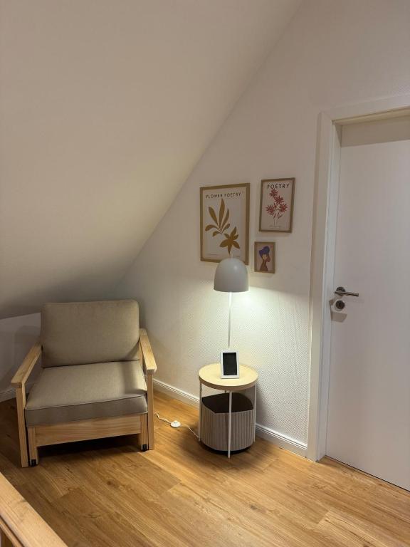a living room with a chair and a lamp at LMB stays in Recklinghausen