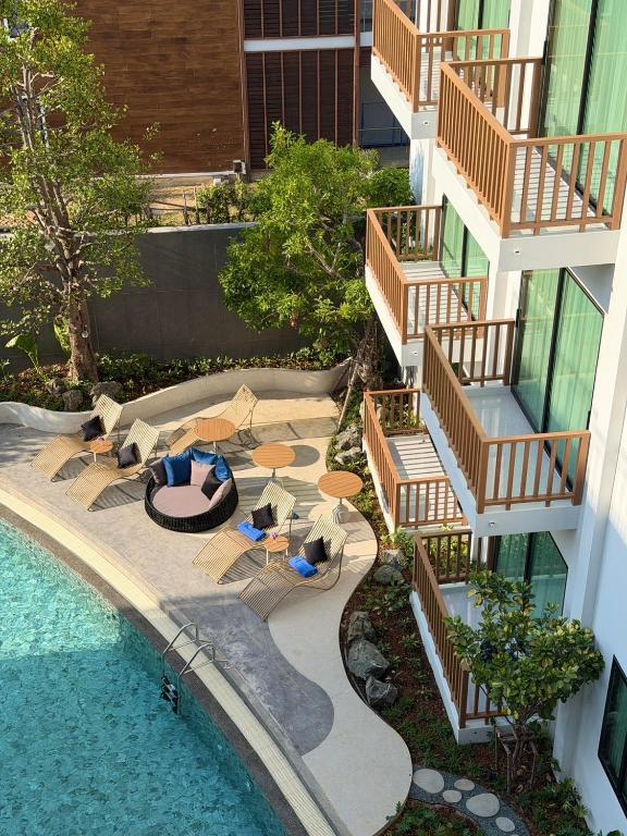 an aerial view of a building with a swimming pool at After Rain Hotel in Chiang Mai