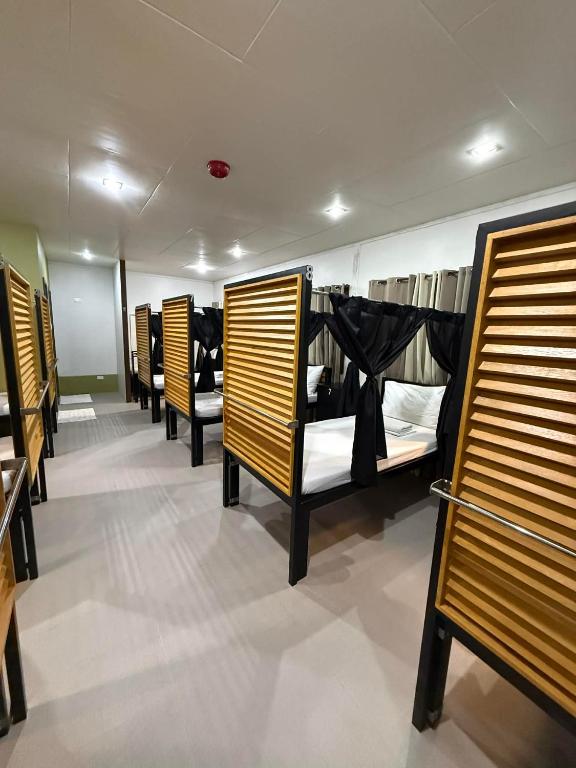 a row of bunk beds in a room at Happy Camper Hostel in Coron