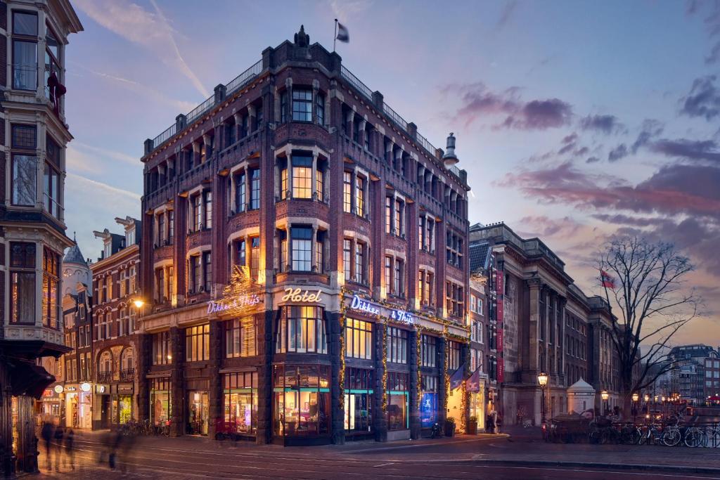 a large brick building on a city street at night at Dikker & Thijs Hotel in Amsterdam