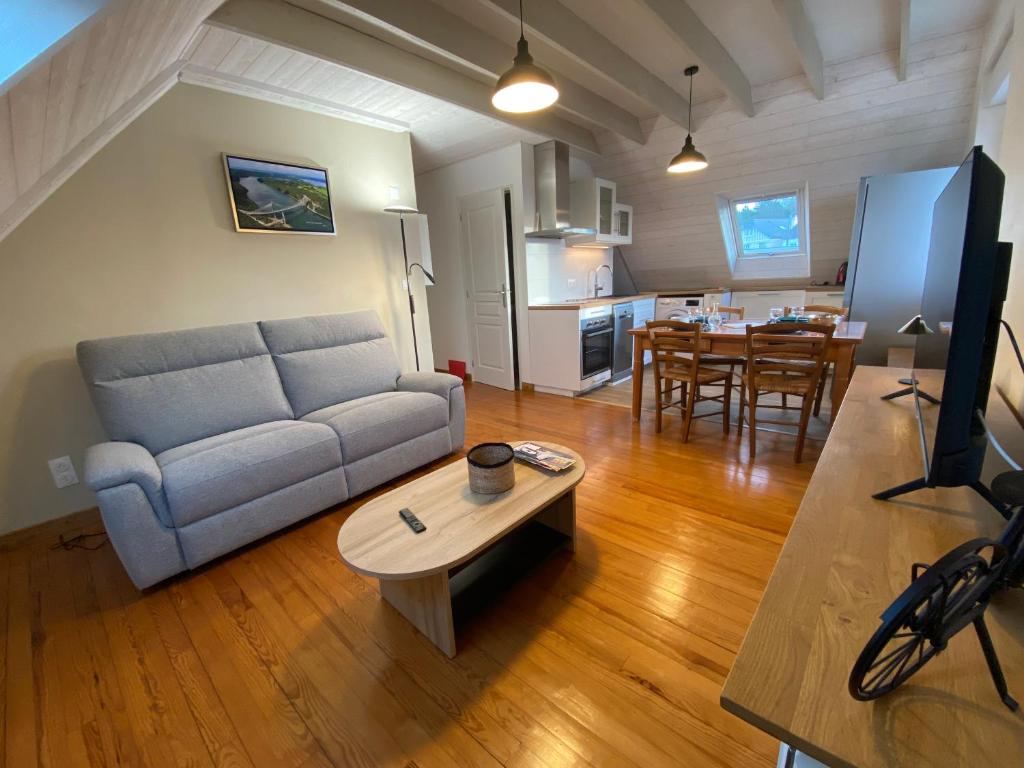 a living room with a couch and a table at Les mouettes rieuses in Telgruc-sur-Mer