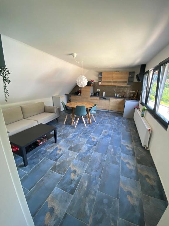 a living room with a couch and a table at Relaxen am Waldesrand Fewo 2 in Ahrbrück