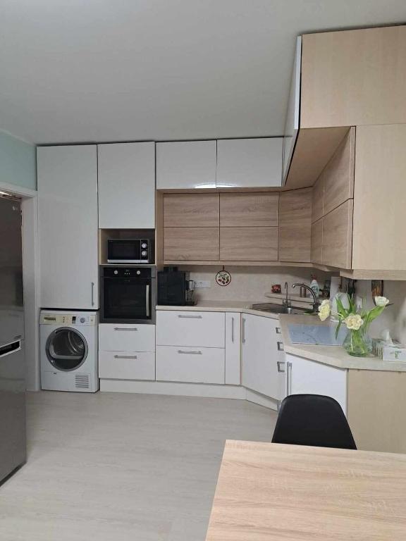 a large kitchen with white cabinets and appliances at A 3-bedroom apartment on the second floor in Tallinn