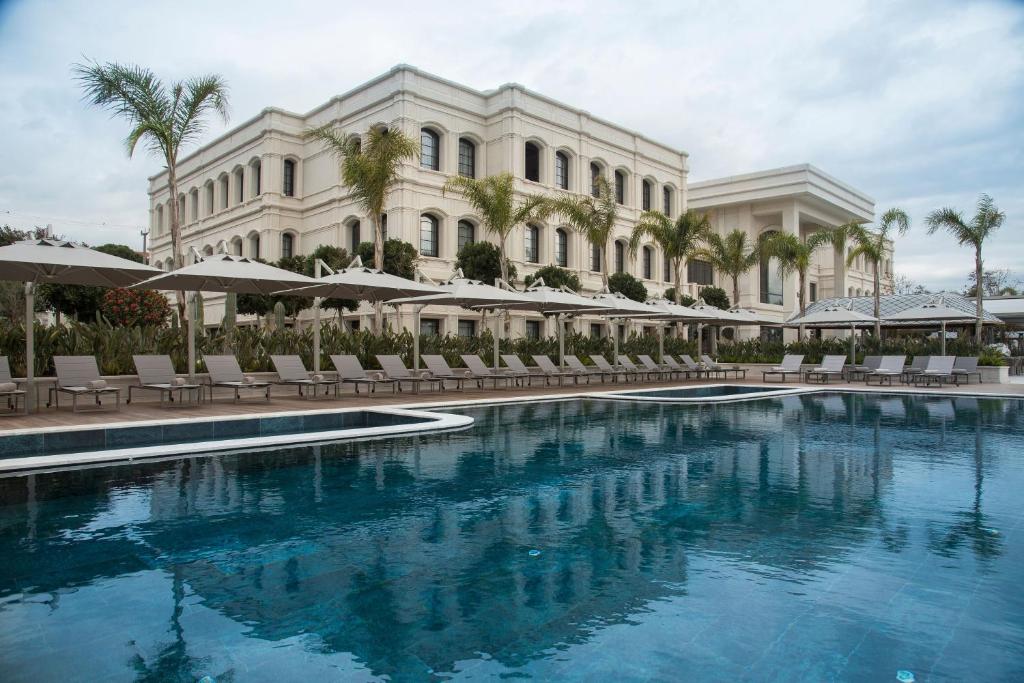 a large swimming pool in front of a building at Cunda Callisto Hotel & Spa Adult Only 12 in Ayvalık