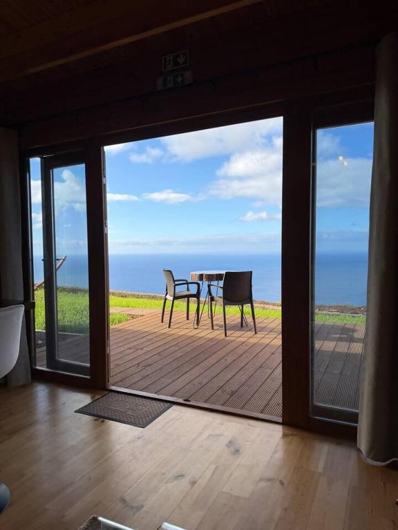a view of a patio with a table and chairs at Sunset Eco Shelter 1 in Ponta do Pargo