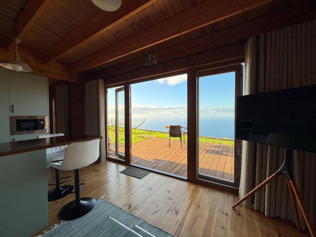 a room with a large window with a view of the ocean at Sunset Eco Shelter 2 in Ponta do Pargo