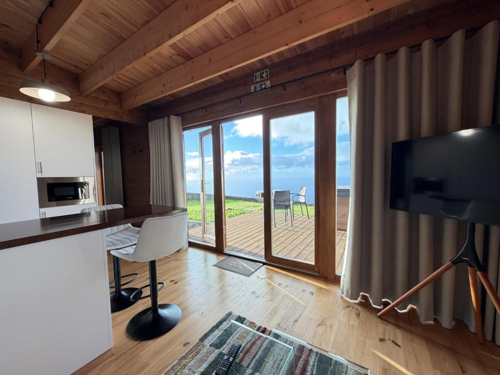 a living room with a view of the ocean at Sunset Eco Shelter 3 in Ponta do Pargo