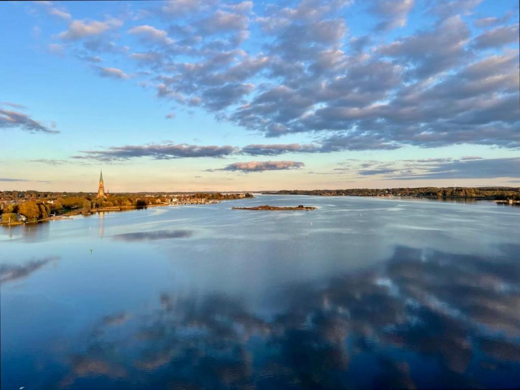 a view of a river with a cloudy sky at Panoramablick Ostseefjord Schlei in Schleswig