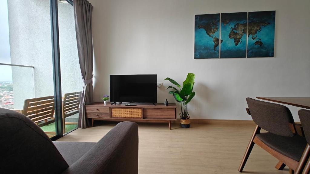 a living room with a flat screen tv on a table at The Grand SS15 Sunway 4Pax 2BRs City View - Free WiFi, Infinity Pool & Gym in Subang Jaya