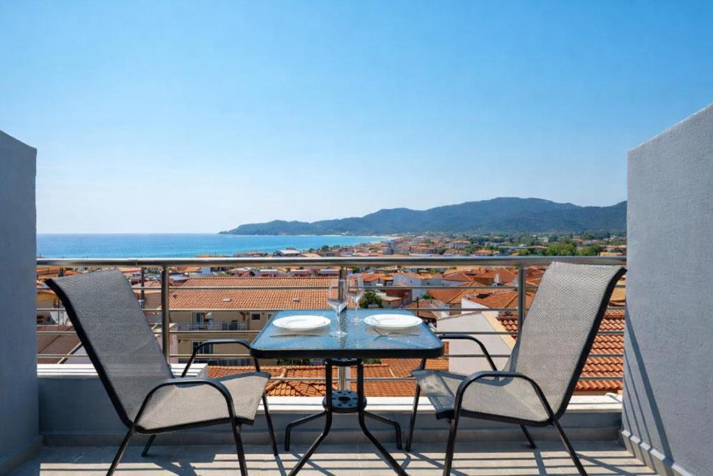 a table and chairs on a balcony with a view at Blue Horizon Sarti Chalkidiki in Sarti