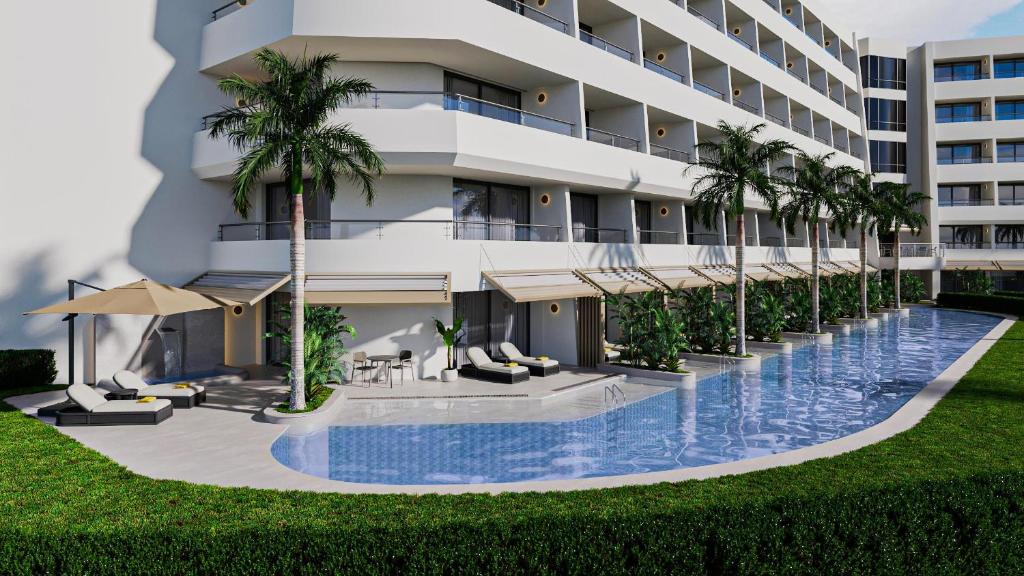 an exterior view of a hotel with a swimming pool and palm trees at Mirage Park Resort - Premium All Inclusive in Kemer