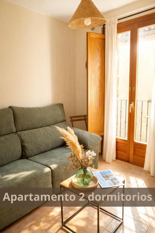 a living room with a couch and a table at Alojamientos Apolonia, La Fresneda in La Fresneda