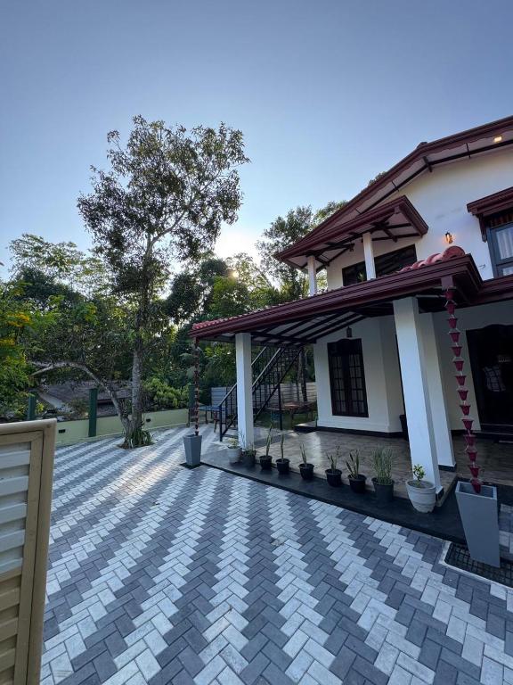 a patio in front of a house at Kahanda Cinnamon Villa in Angulugaha