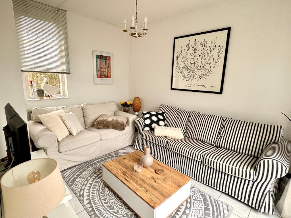 a living room with a couch and a table at De Korre 10 in Callantsoog
