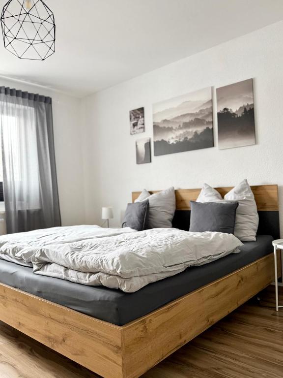 a bedroom with a large bed with a wooden frame at City Flair by Zirwick Apartment in Weiden