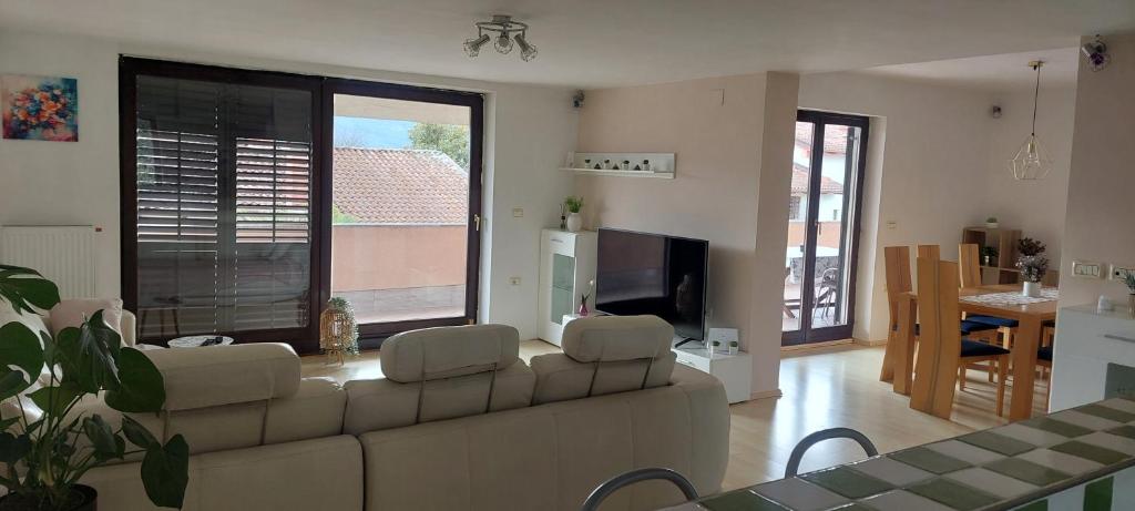 a living room with a couch and a table at apartma Kiana in Šempeter pri Gorici