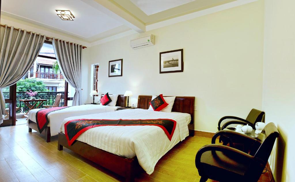 Postel nebo postele na pokoji v ubytování An Hoi Town Homestay