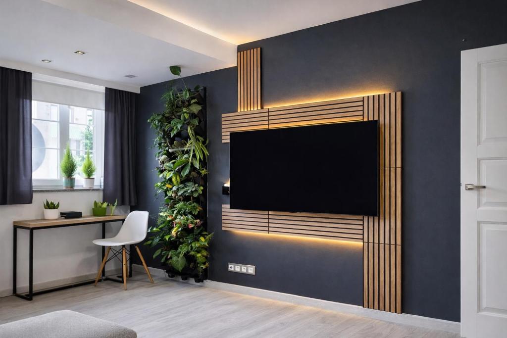 a living room with a flat screen tv on a wall at Wonderful Dream Apartament z widokiem na Śnieżkę in Karpacz