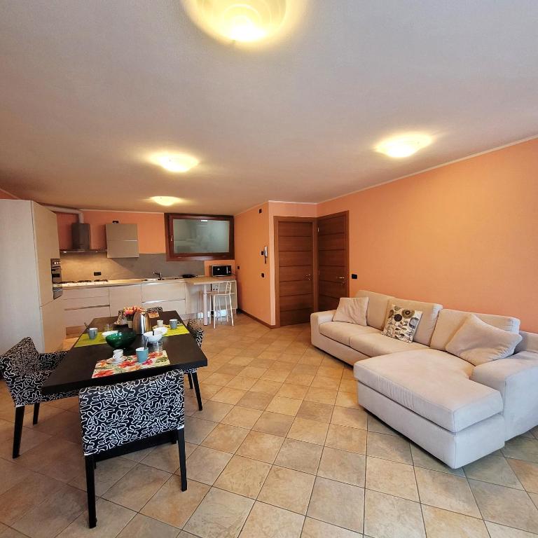 a living room with a couch and a table at L'Antico Fienile Mountain Lake Iseo Hospitality in Fonteno
