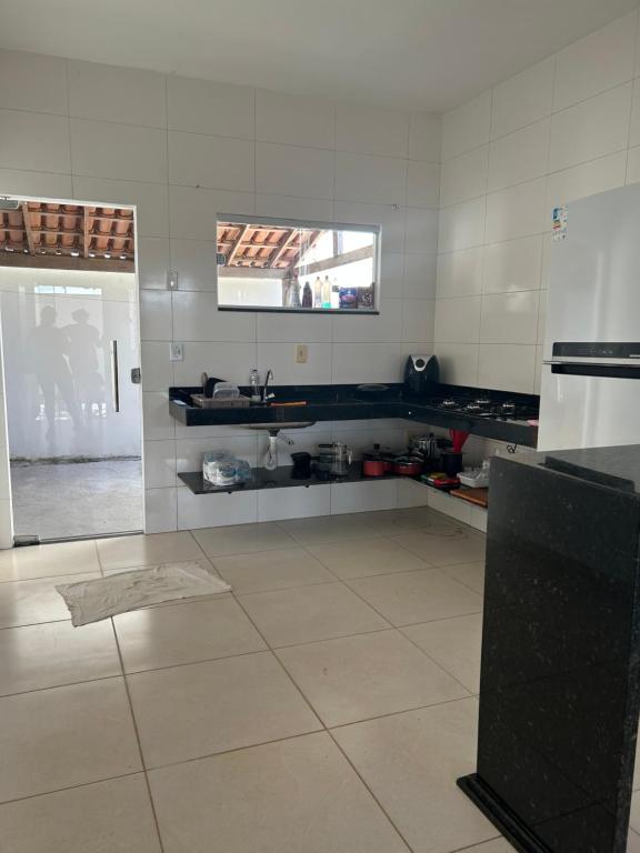 a kitchen with a sink and a white tiled floor at Casa Prado in Prado