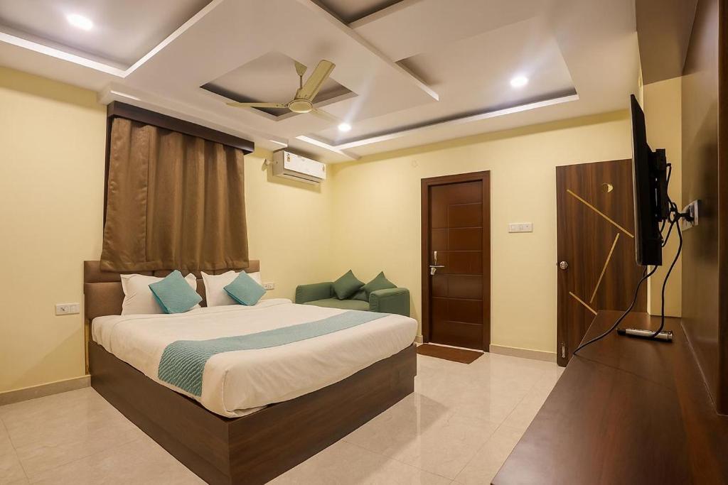 a bedroom with a bed and a ceiling fan at Olive Hotel in Hyderabad