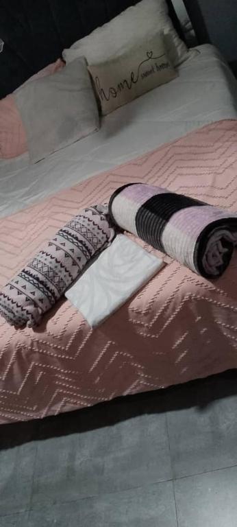 a comforter on a bed with a comforter on it at wamis Fully serviced apartments in Solwezi