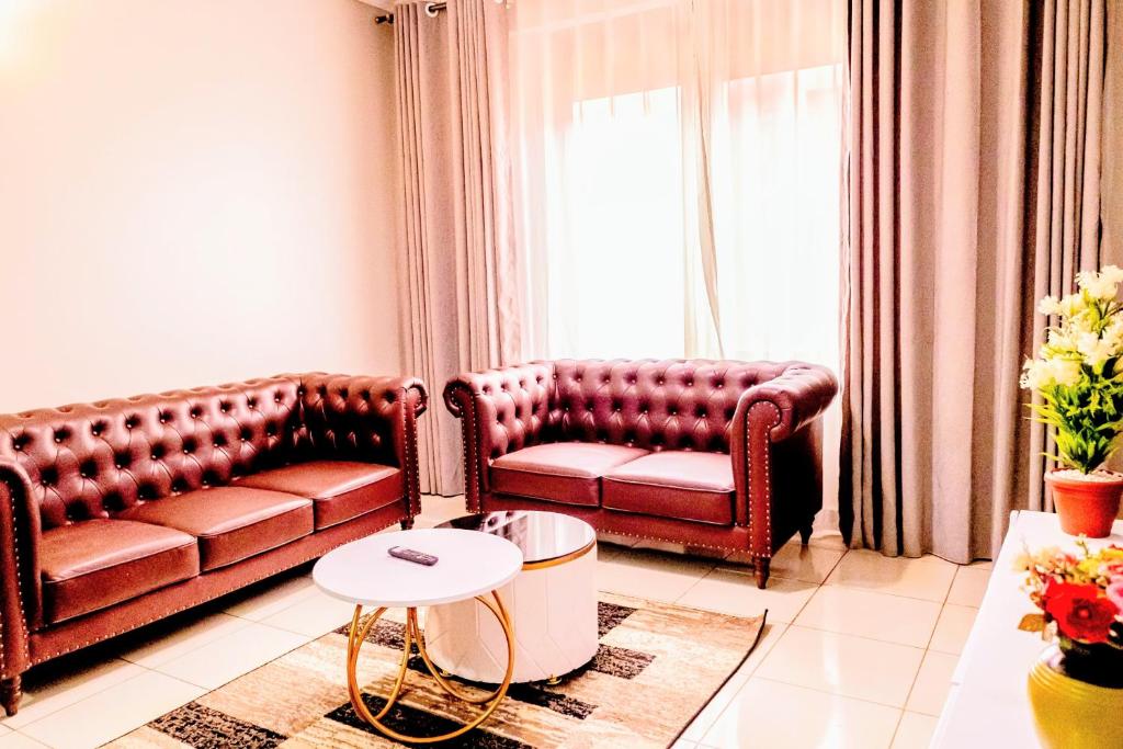 a living room with a couch and a table at EKay's Space Najjera1 in Namugongo