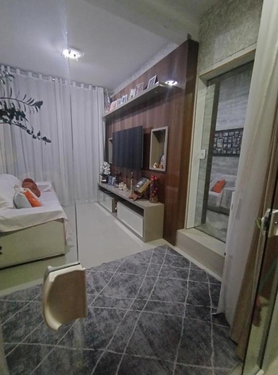 a bedroom with a bed and a television in a room at Ap bom descanso in Palhoça