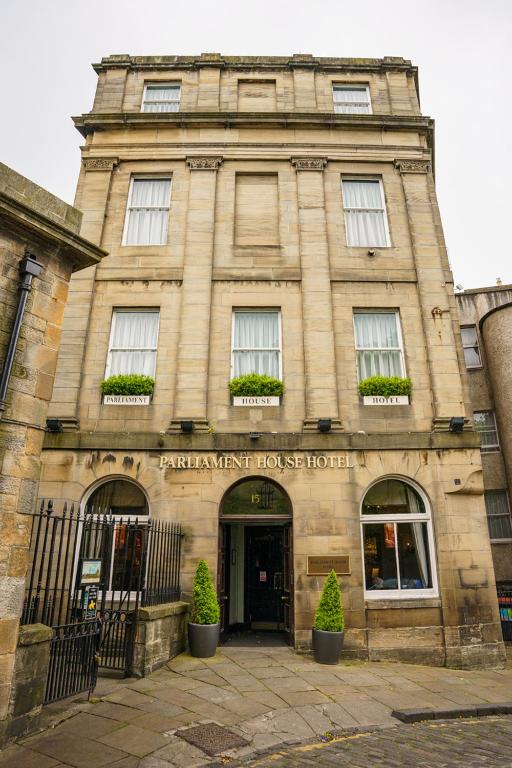 a large stone building with a sign on it at The Parliament House Hotel in Edinburgh