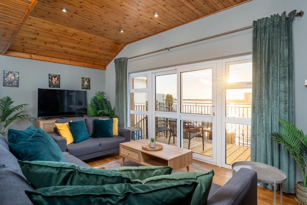 a living room with a couch and a table at Shannon View Jungle House in Athlone