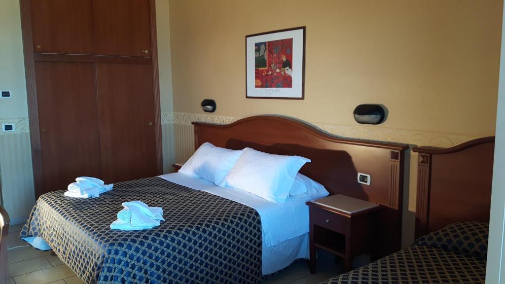 Postel nebo postele na pokoji v ubytování Hotel Grifone