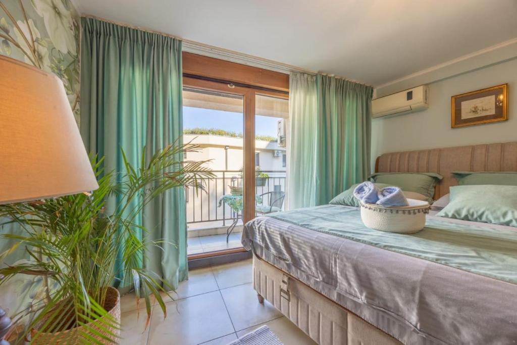 a bedroom with a bed and a large window at Centre Budva Blue in Budva