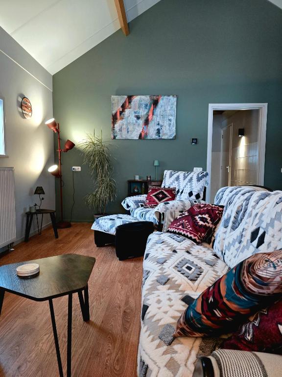 a living room with a couch and a table at Whispering O - B&B Ermelo Speuld On the Veluwe in Ermelo
