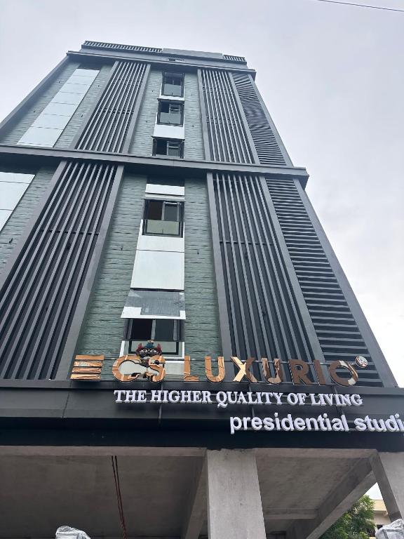 a tall building with a sign on it at CS Luxurio Presendential Suites Gachibowli in Hyderabad