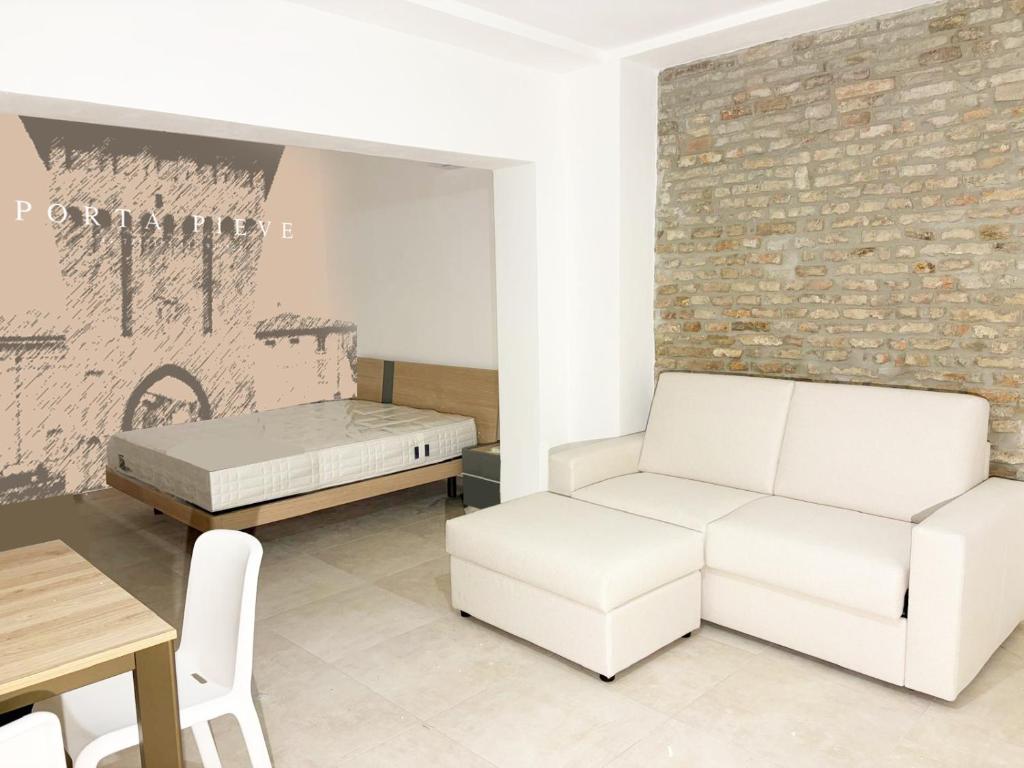 a living room with a couch and a bed at Ugo Bassi 98 in Cento