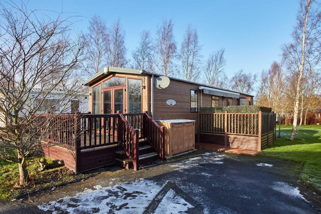 a small cabin with a porch and a fence at Host & Stay - 10th Avenue in Morpeth