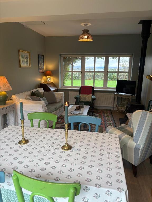 a living room with a table and a couch at Croagh Patrick Lodge Apartment in Westport