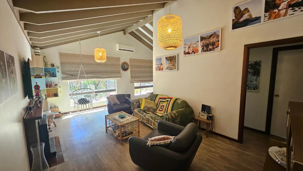 a living room with two chairs and a couch at Ocean Drive Home: 3 bedroom 70s-inspired… - 19110 in Bunbury