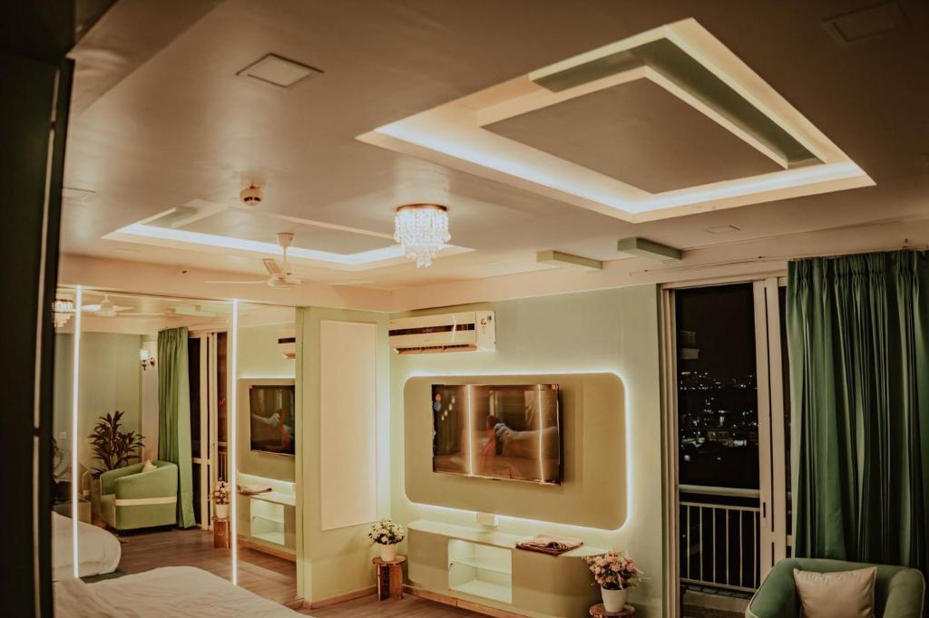 a room with a bed and a large window at Piyush stay in Lucknow