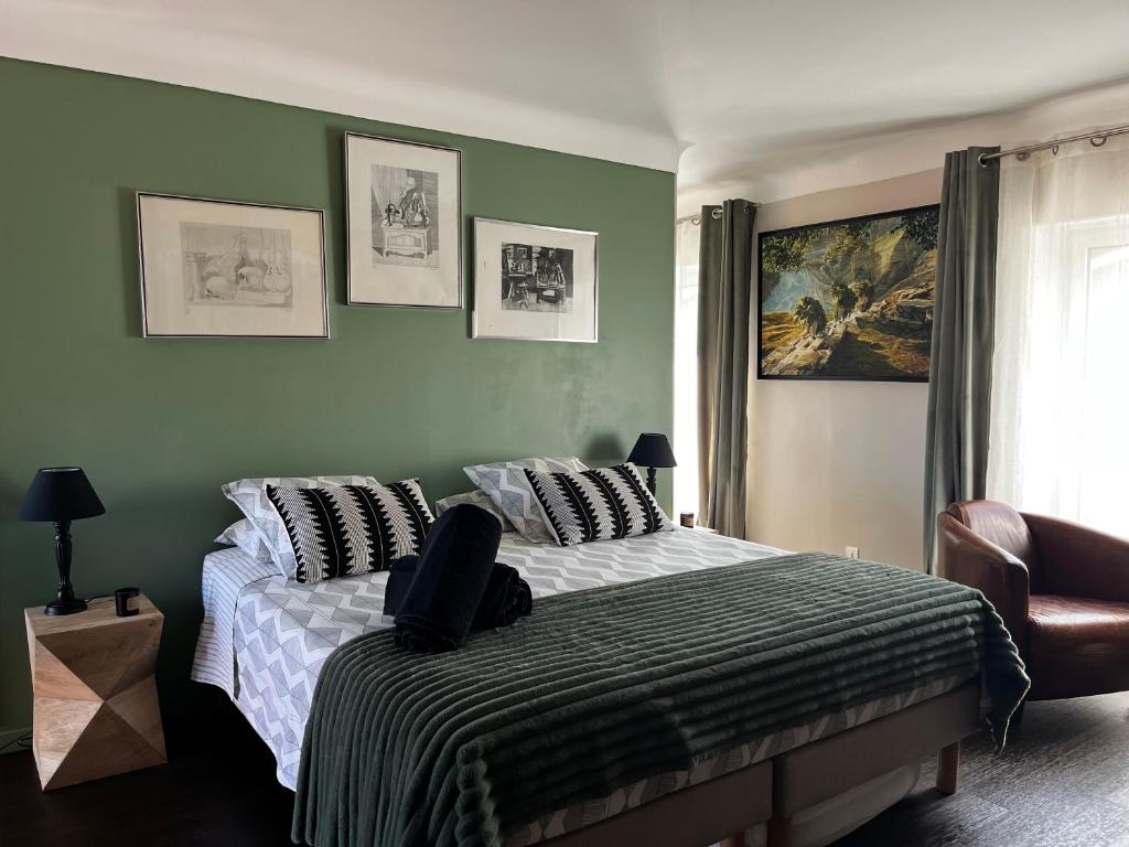 a bedroom with a bed with a laptop on it at Les Trois soleils in Roquebrune-sur-Argens